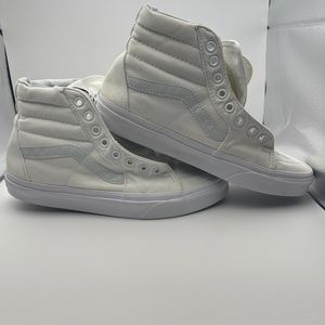 All white vans high top skateboard shoes, size 6.5 men’s, size 8 women’s.